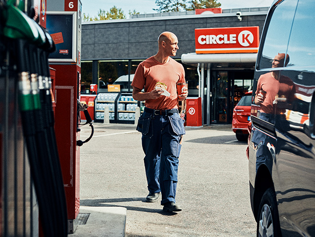 Driver walking out of Circle K with snacks and drink