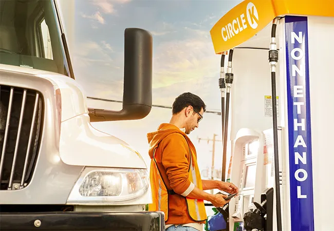 Truck driver choosing fuel type from Circle K Pro pump