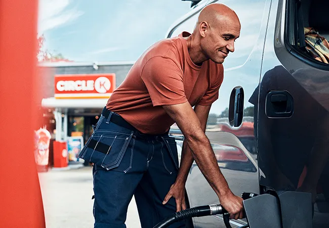 Van driver fueling van at Circle K station